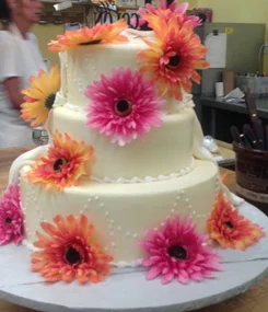 Tiered wedding cake with gerbera daisies